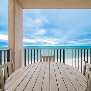 Relax at the table on your balcony, soaking in coastal views and the soothing sounds of the beach below
