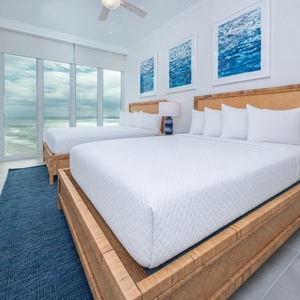 Wake to a breathtaking sunrise in this queen guest suite with two cozy beds and expansive views from the windows