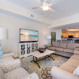 Relax on plush sofas in the cozy living room, enjoying family movie nights while surrounded by inviting decor