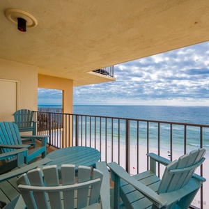 Relax on the turquoise chairs of this balcony while enjoying breathtaking views of the tranquil shoreline