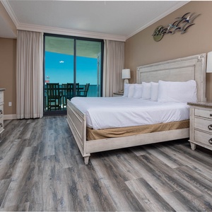 Sleep peacefully in this spacious master bedroom with a plush king bed, stylish decor, and access to the balcony