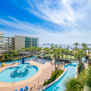 Lounge on the balcony overlooking the refreshing pool, lazy river, stunning bay water, and marina activity