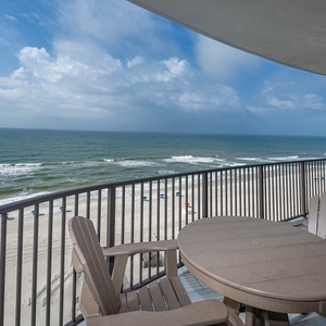 Savor the fresh air at the outdoor table, with views of the beach and gentle waves inviting relaxation