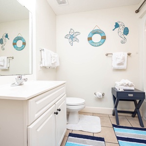 Enjoy a relaxing shower after a day of adventure in this guest bath with stylish accents and fluffy towels