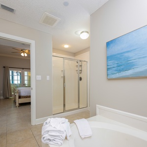 Refresh in the master bath after a day at the beach with a soothing jetted tub and relaxing walk-in shower