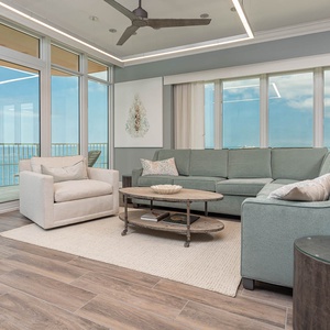Relax on the cozy sofa with a queen sleeper in this inviting family room with breathtaking beachfront views