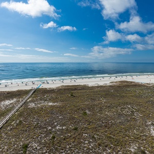 Impressive view of the beach and gentle gulf waves, inviting guests to relax under the sunny sky