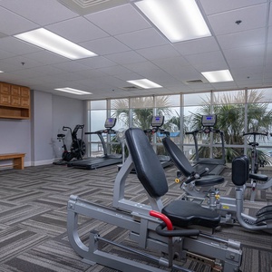 Remain fit in this bright fitness center with views of the beach at Seawind, featuring modern equipment for your workout