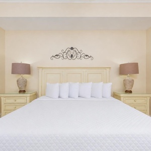 Master bedroom featuring a plush king bed, soft linens, and charming coastal decor