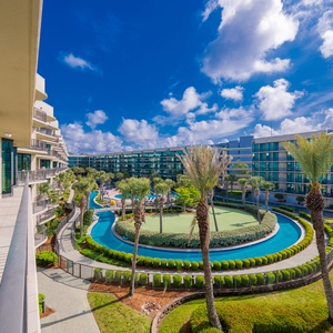 Relax on the airy balcony, soaking in the warm sun while overlooking lush grounds and sparkling pools below