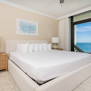 Unwind in the master bedroom, featuring a king bed and stunning views of the beach