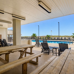 Relax at the shaded picnic area with grills, perfect for gatherings and enjoying views of the nearby boardwalk and pool