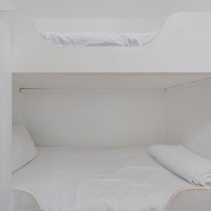 This cozy space features a bunk bed and a view of the beach, with a bright living area just steps away