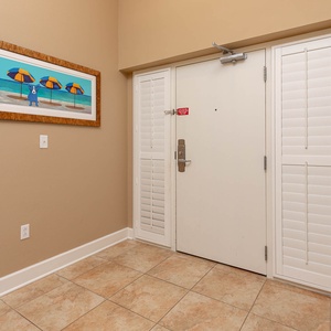 This welcoming entryway features a vibrant beach-themed artwork setting a cheerful tone for your stay