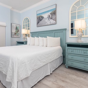Relax on the king bed in the guest suite and read by lamp light while coastal artwork brightens the room