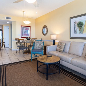 Relax in the inviting living area, featuring a comfortable sofa and a round dining table for shared meals and conversation