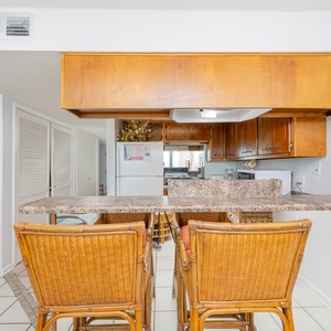 Kitchen with wooden cabinetry and a cozy breakfast bar, perfect for enjoying morning coffee