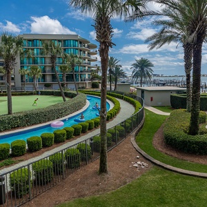 Unwind by the pool and lazy river, where lush greenery frames a tranquil stroll along the winding pathways