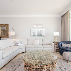 Unwind on the spacious sectional sofa, surrounded by coastal decor and a unique coffee table for relaxed gatherings