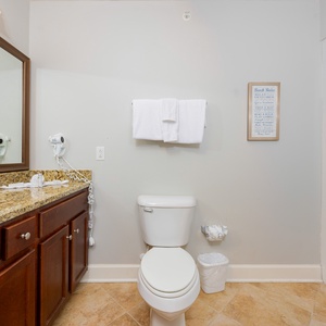 Rejuvenate with a refreshing shower in this guest bathroom, surrounded by inviting decor and thoughtful amenities