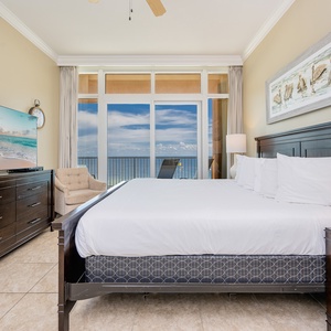 Relax in the spacious master with a king bed, large TV, and stunning beachfront balcony views