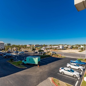 Enjoy a vibrant view of the lively surroundings and palm trees from this inviting balcony space