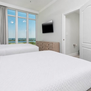 Open the tall drapes and wake on soft queen beds while you watch the gulf and shoreline from this guest room
