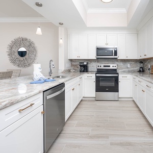 Cook and gather in this stylish kitchen featuring stainless appliances and a spacious countertop for meal prep