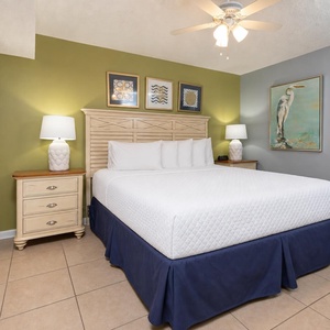 Unwind in the tranquil bedroom featuring a king bed, soft lighting, and coastal decor for a restful stay