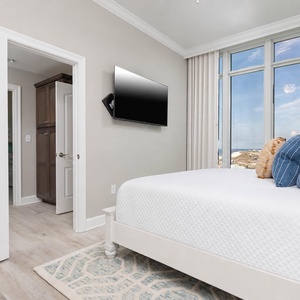 Draw the curtains to reveal the gulf and beach beyond from this guest suite and cozy up in the plush king bed