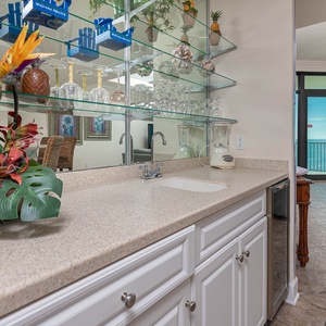 Create refreshing drinks at your wet bar, surrounded by vibrant decor and inviting beach vibes
