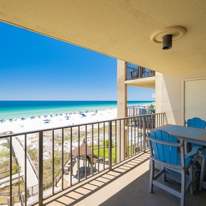 The gulf stretches before you as you relax on your balcony with a refreshing drink at the table