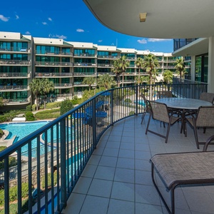 Breathe in the coastal air as you relax on the balcony, taking in the vibrant pool views and swaying palms