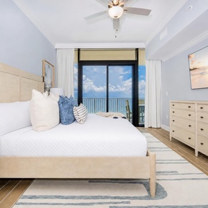 Tranquil master bedroom featuring a king bed, stylish decor, and expansive beachfront views from your balcony