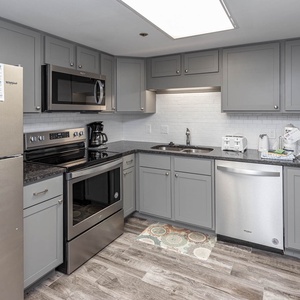 Prepare meals in this stylish kitchen featuring stainless appliances and ample counter space