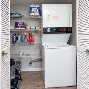 Conveniently tackle laundry with the stacked washer and dryer, alongside storage for cleaning supplies and essentials