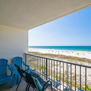 Savor the vibrant beach views as you relax in your seating on the balcony, perfect for unwinding after a day of adventure
