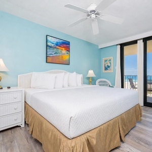 Calm blue walls frame your king master suite with relaxing beach views from the balcony