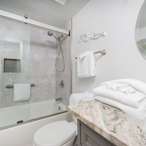 Experience refreshing moments in the guest bath, surrounded by serene decor, for a rejuvenating start to your day