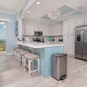 Sip your morning coffee at the breakfast bar and get ready for a beach day in this stylish space
