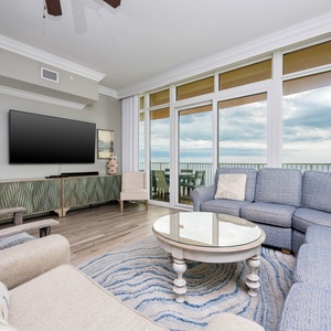 Experience cozy gatherings in the inviting living area, with panoramic coast views enhancing your relaxation