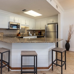 Enjoy cooking in the stylish kitchen with ample counter space, stainless appliances, and a cozy breakfast bar