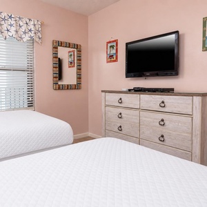 Rest in this cheerful guest room with two double beds, a flat-screen TV, and beach-themed decor for a relaxing getaway