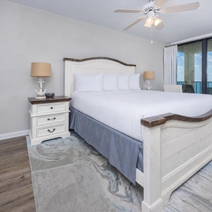 Master bedroom featuring a plush king bed and stunning views from the balcony, perfect for relaxation