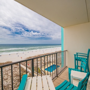 Enjoy stunning beachfront views from this cozy balcony, complete with comfortable seating for relaxation
