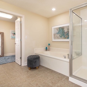 Spacious master bathroom featuring a relaxing jetted tub, a glass walk-in shower, and stylish decor for your comfort