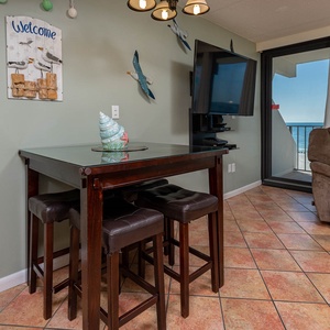 This inviting space features a cozy seating area with a view of the beachfront, perfect for relaxation and enjoyment