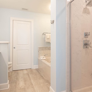 Indulge in relaxation in the master bath with a refreshing walk-in shower and soothing jetted tub