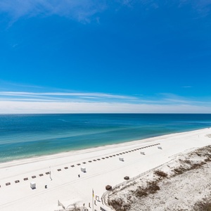 Gaze at the tranquil waters and expansive shoreline, perfect for peaceful moments and beachside relaxation