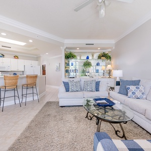 Unwind on the plush sofa, where coastal decor invites you to relax and enjoy shared moments with loved ones